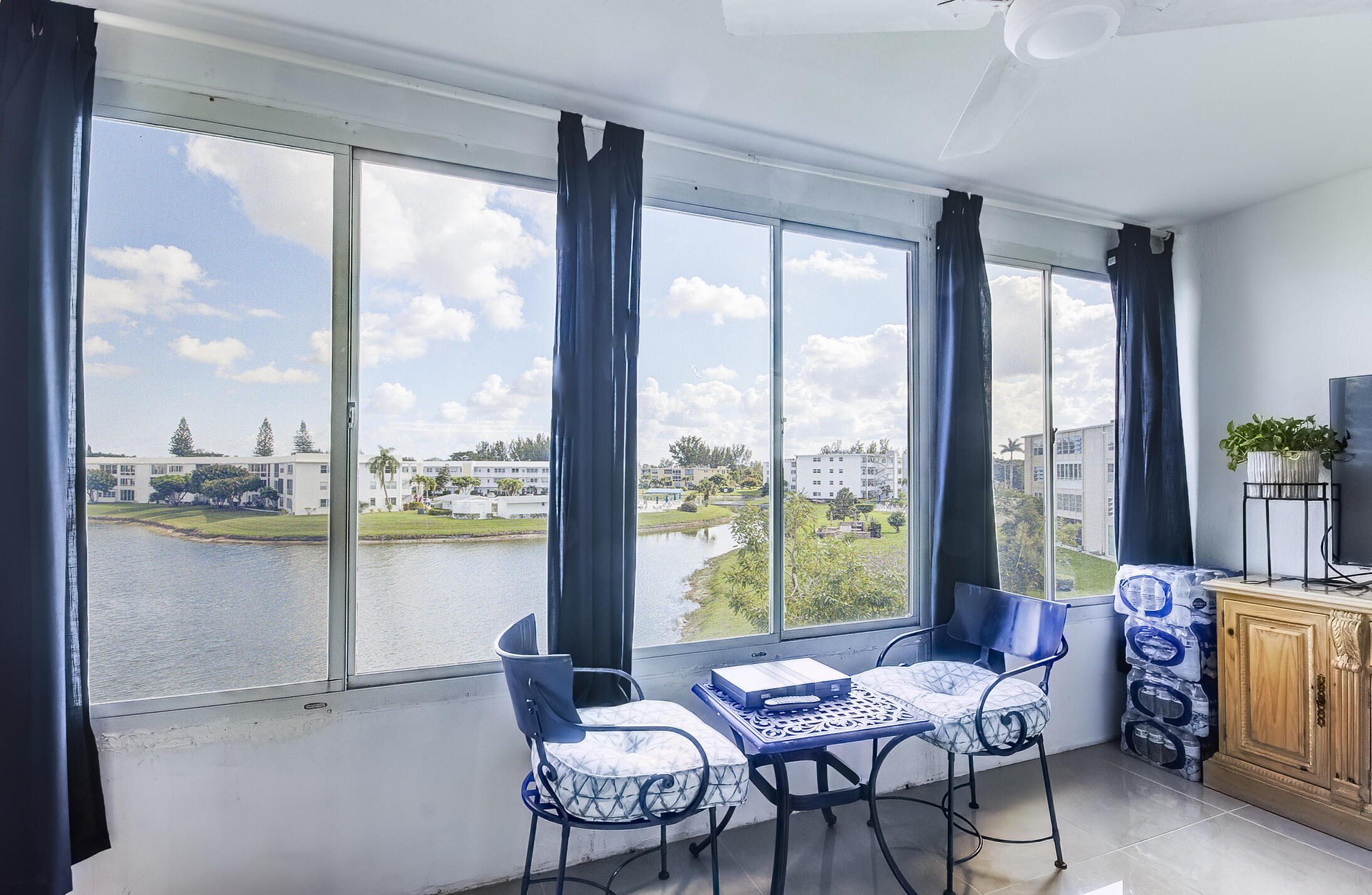 363 Wellington J West Palm Beach, FL 33417 - Photo 16 of 17 a living room with furniture and floor to ceiling windows