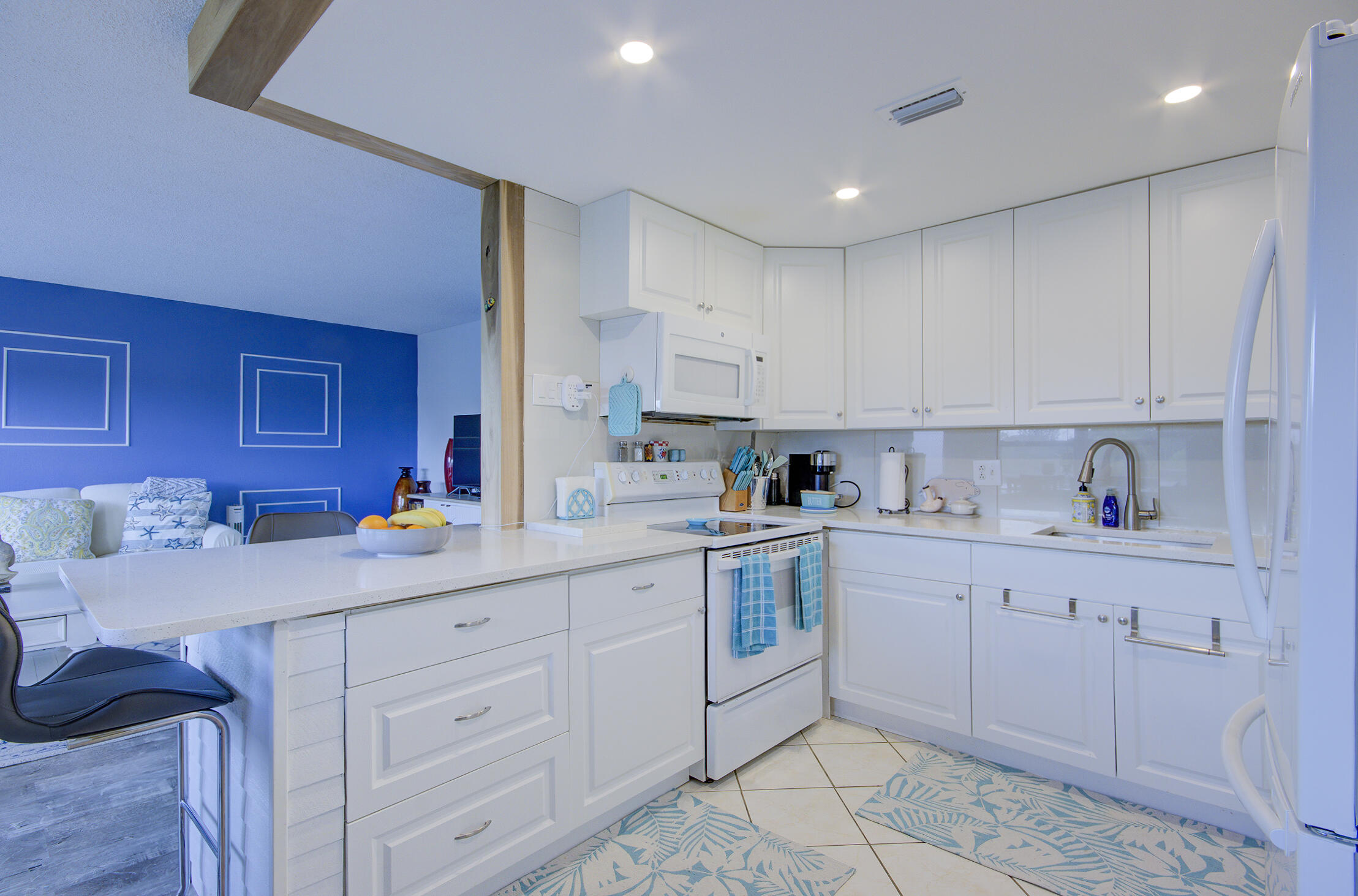 363 Wellington J West Palm Beach, FL 33417 - Photo 5 of 17 a kitchen with cabinets appliances and a sink