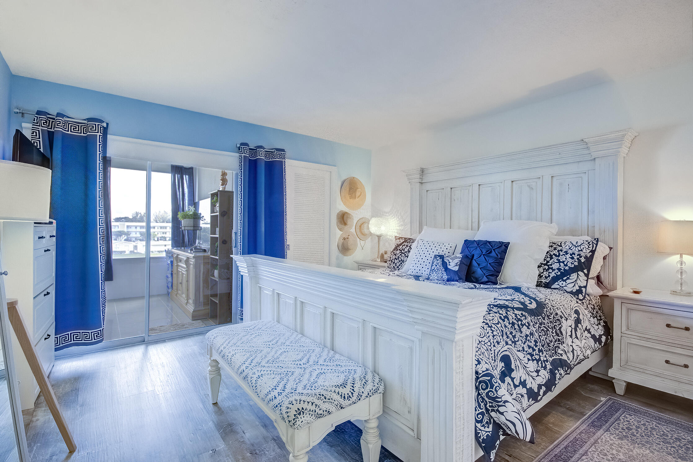 363 Wellington J West Palm Beach, FL 33417 - Photo 8 of 17 a bedroom with a bed and a dresser with mirror