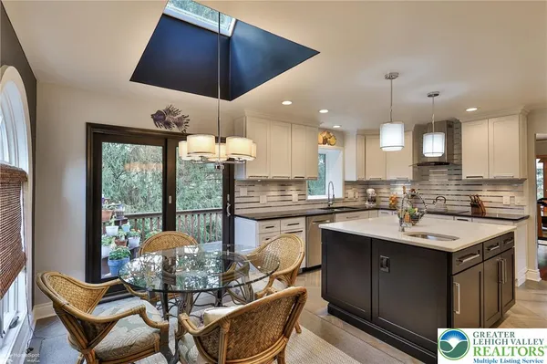 a kitchen with a sink a counter space cabinets and stainless steel appliances