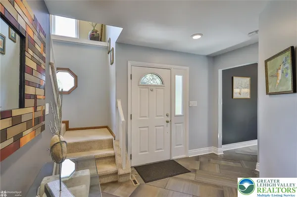 a view of an entryway with wooden floor