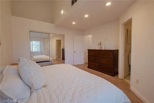 a bedroom with a bed and a dresser