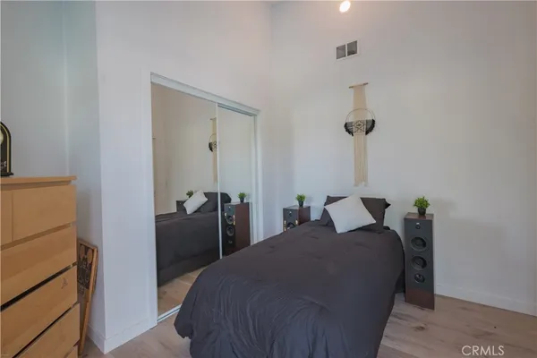 a bedroom with a bed and a dresser
