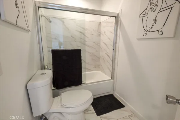 a bathroom with a toilet and a shower