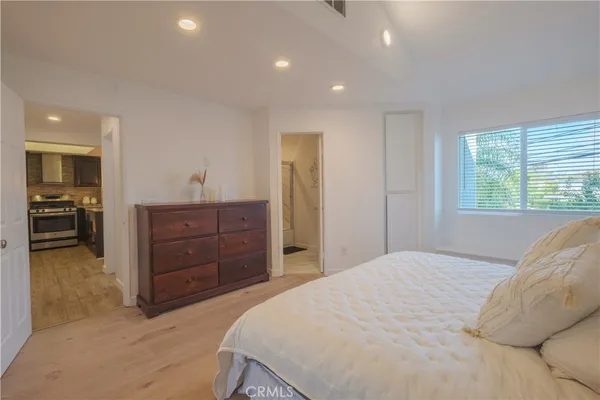 a bedroom with a bed and a dresser