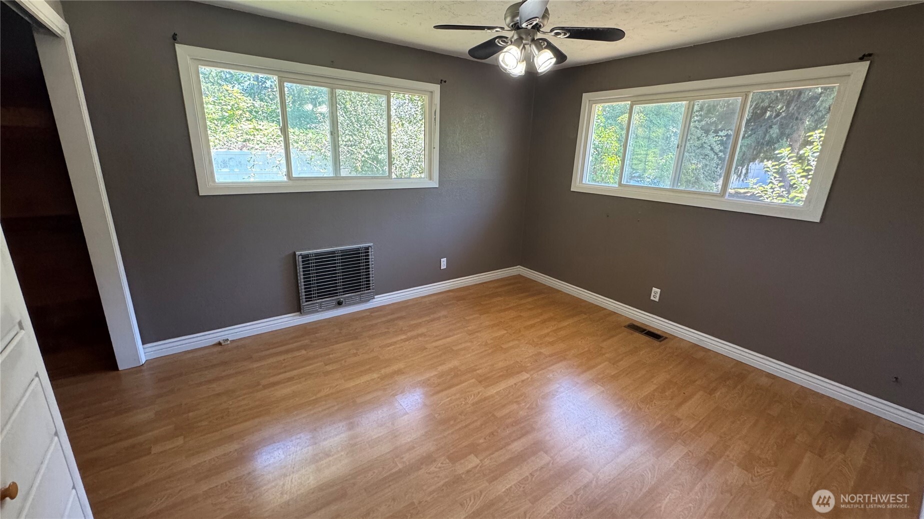 1245 West Axton Road Ferndale, WA 98248 - Photo 11 of 30 a view of empty room with wooden floor and fan