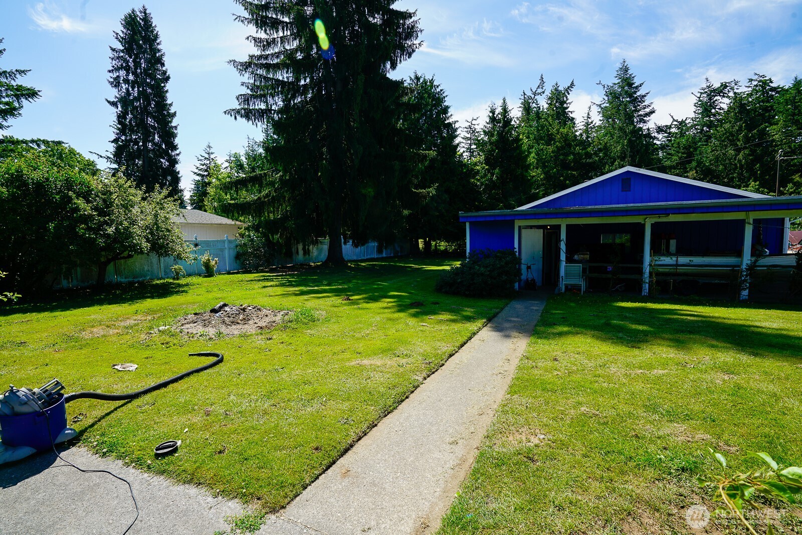 1245 West Axton Road Ferndale, WA 98248 - Photo 5 of 30 a view of a patio with a table and chairs under an umbrella
