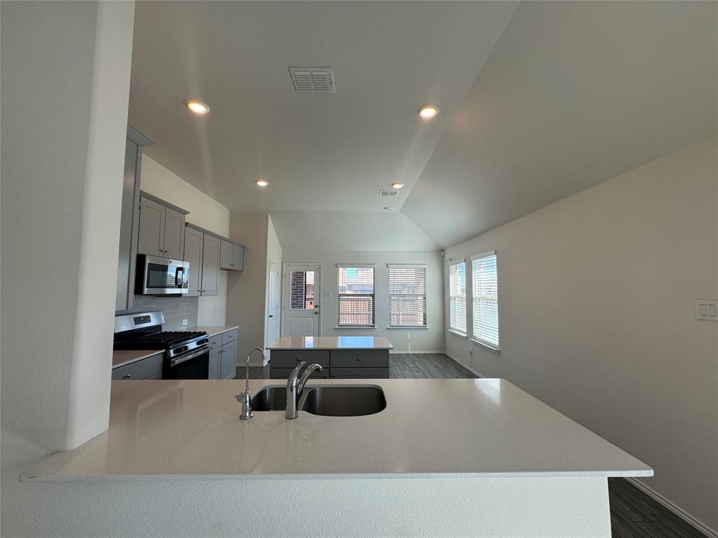 4700 Essonite Road Little Elm, TX 76227 - Photo 16 of 37 a large white kitchen with a large window