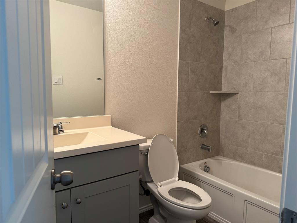 4700 Essonite Road Little Elm, TX 76227 - Photo 27 of 37 a bathroom with a sink a toilet and a bathtub