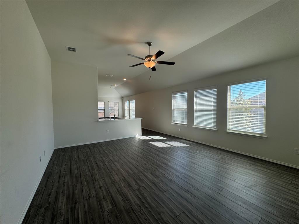 4700 Essonite Road Little Elm, TX 76227 - Photo 8 of 37 an empty room with wooden floor and windows
