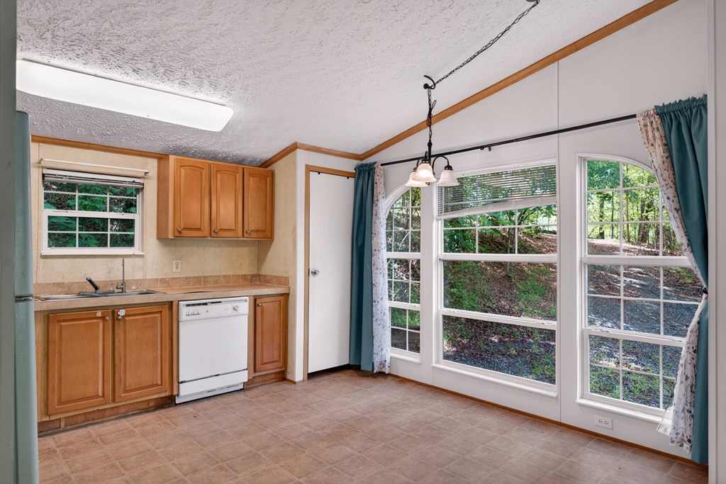 282 West Cherry Road Hayesville, NC 28904 - Photo 7 of 45 a kitchen with stainless steel appliances granite countertop a stove a sink and a refrigerator