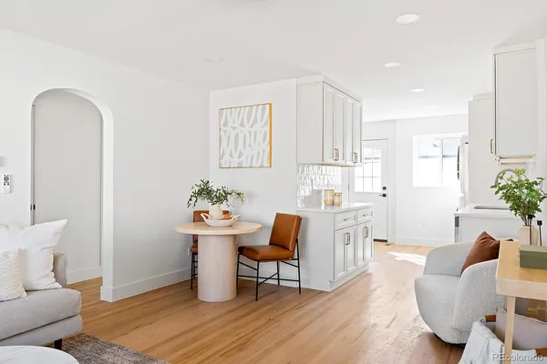 a living room with furniture flowerpot and a potted plant