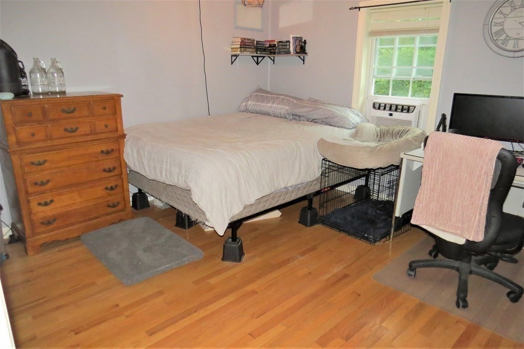 114 North Main Street Salem, NH 03079 - Photo 12 of 26 a bedroom with a bed and wooden floor