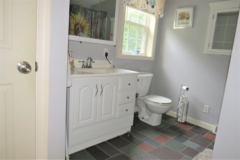 114 North Main Street Salem, NH 03079 - Photo 13 of 26 a bathroom with a toilet a sink and a window