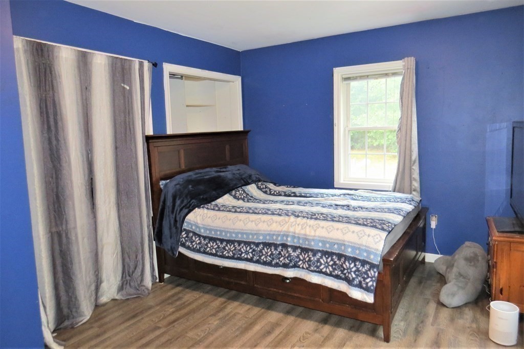 114 North Main Street Salem, NH 03079 - Photo 14 of 26 a bedroom with a bed and a window