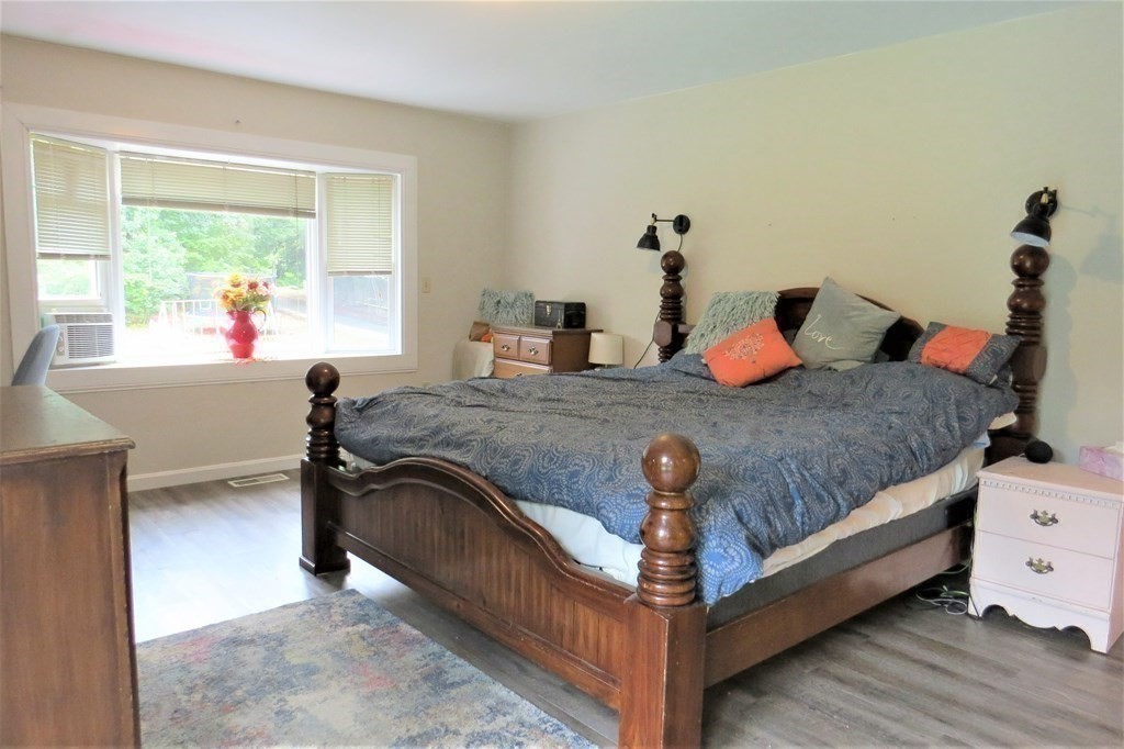 114 North Main Street Salem, NH 03079 - Photo 15 of 26 a bedroom with a bed and wooden floor