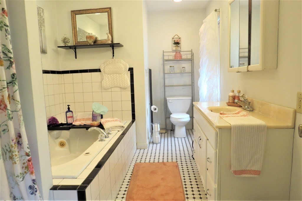 114 North Main Street Salem, NH 03079 - Photo 16 of 26 a bathroom with a sink a toilet and shower