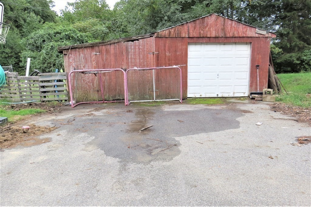 114 North Main Street Salem, NH 03079 - Photo 19 of 26 a front view of a house with a yard and garage