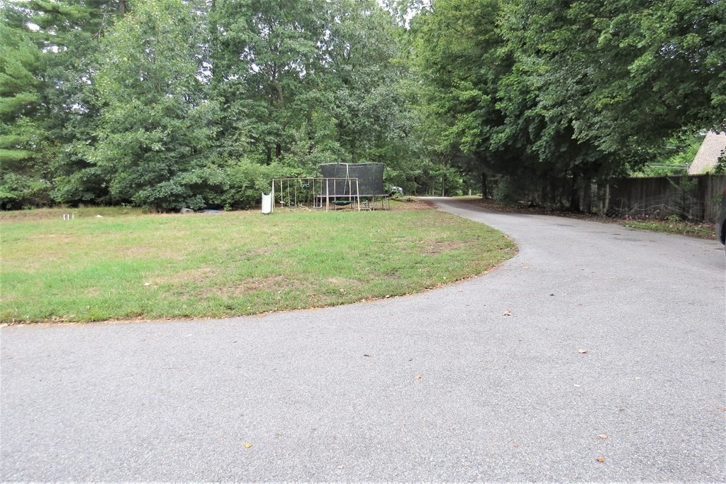 114 North Main Street Salem, NH 03079 - Photo 20 of 26 a view of a backyard with large trees