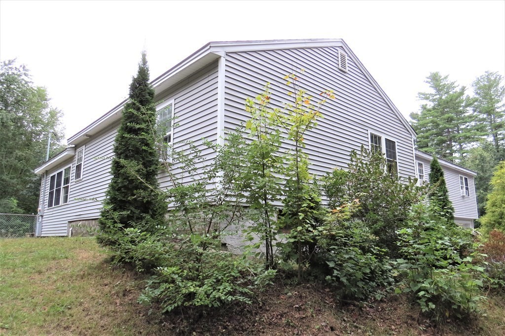 114 North Main Street Salem, NH 03079 - Photo 3 of 26 a close up of a house with plants and trees