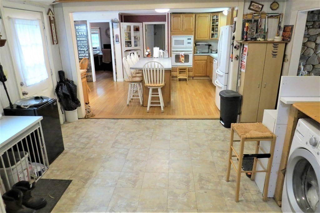 114 North Main Street Salem, NH 03079 - Photo 8 of 26 a living room with furniture a fireplace and a flat screen tv