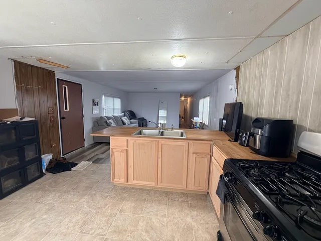 a kitchen with refrigerator and cabinets