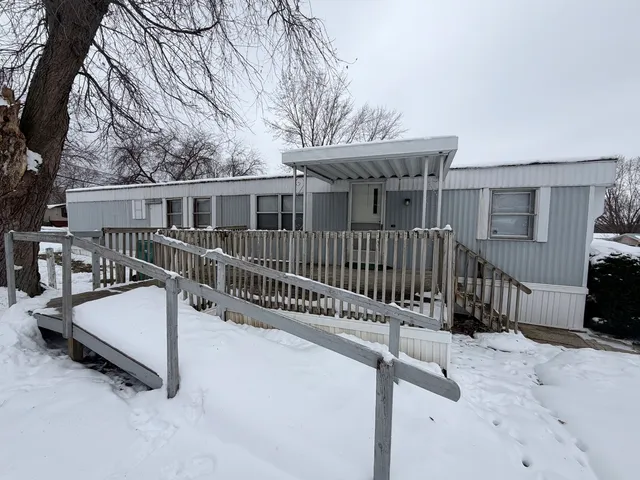 a view of house with a wooden deck and a backyard