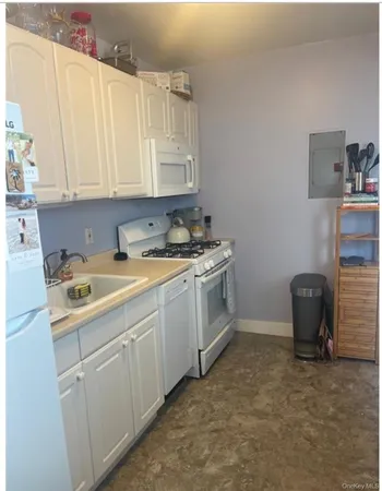 a utility room with cabinets washer and dryer