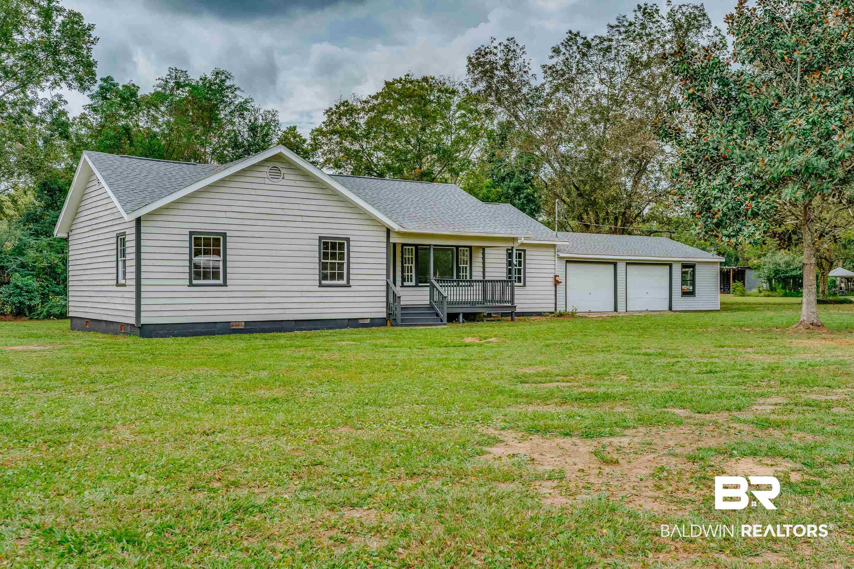 8001 16th Street Irvington, AL 36544 - Photo 3 of 35 Back of property with crawl space, roof with shingles, a yard, and an attached garage