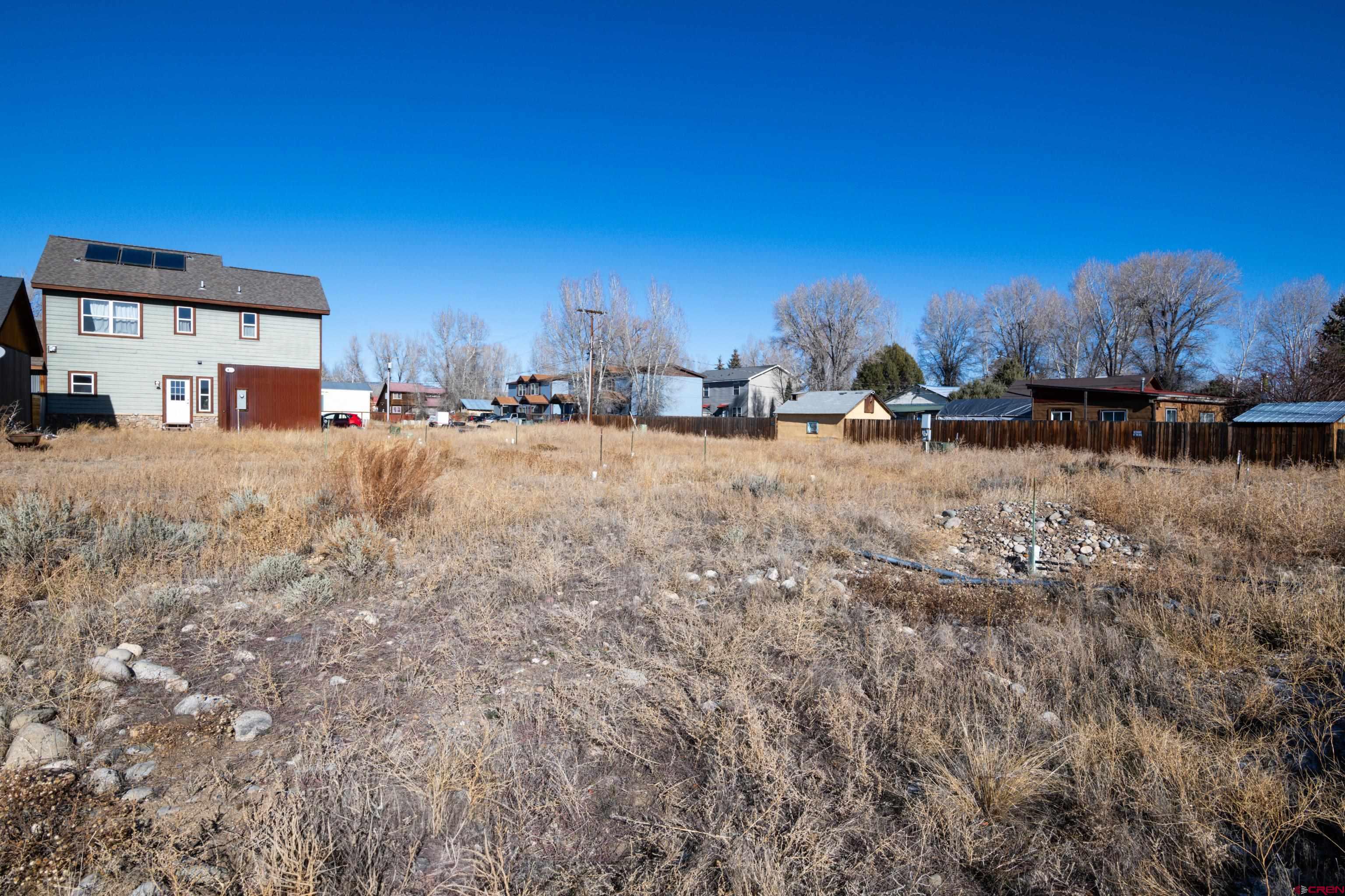 a view of a dirt road and a building