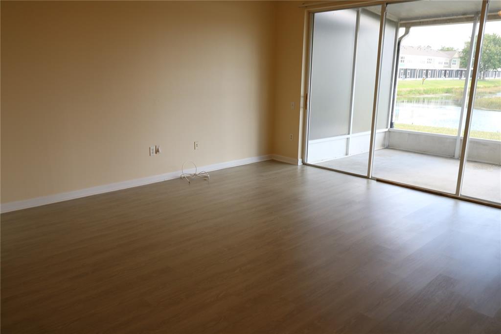 10165 Haverhill Ridge Drive Riverview, FL 33578 - Photo 12 of 33 a view of an empty room with wooden floor and a window