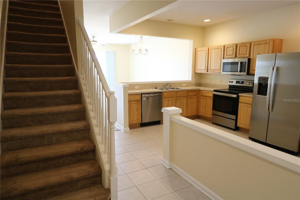 10165 Haverhill Ridge Drive Riverview, FL 33578 - Photo 6 of 33 a kitchen with stainless steel appliances a stove and a refrigerator