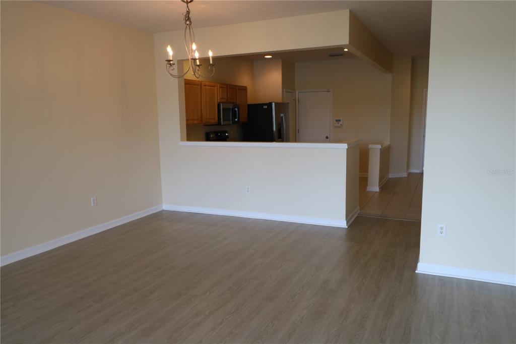 10165 Haverhill Ridge Drive Riverview, FL 33578 - Photo 10 of 33 a view of a room with wooden floor and chandelier
