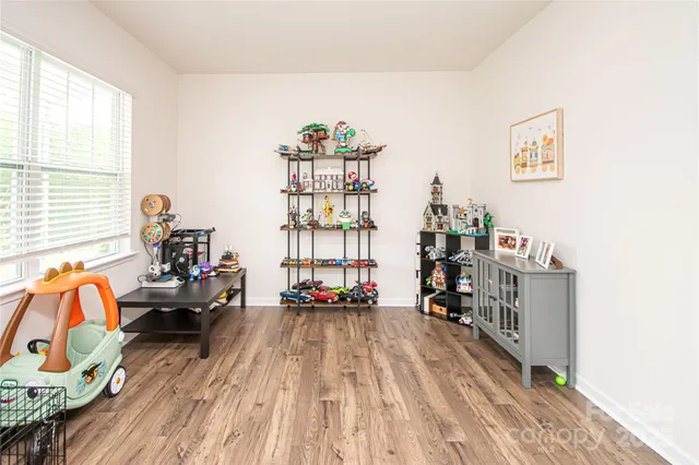 a living room with furniture and a book shelf