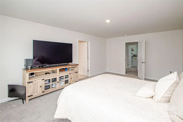 a bedroom with furniture and flat screen tv