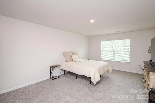 a bed room with a bed and a window