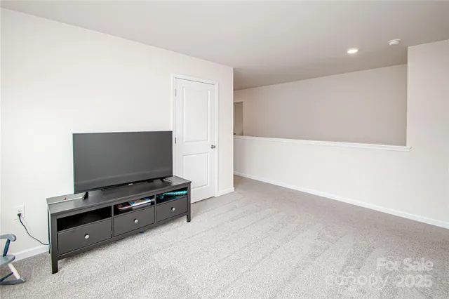 a room with furniture and flat screen tv