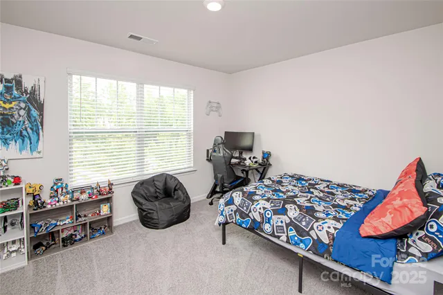 a bedroom with bed and a window