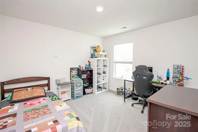 a bedroom with a bed and a desk