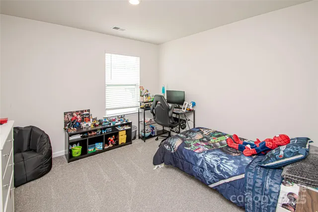 a bedroom with bed and a window