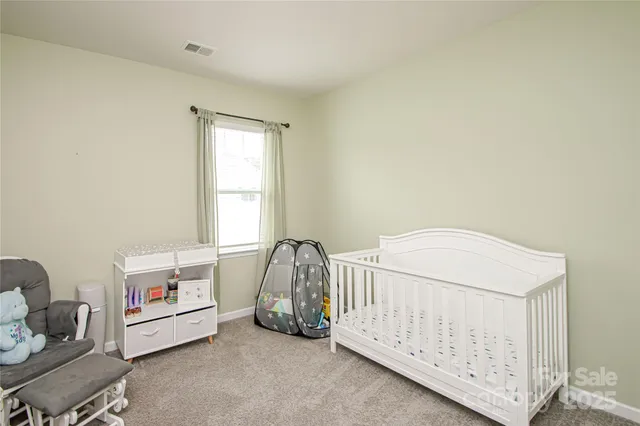 a bed room with a bed and a window