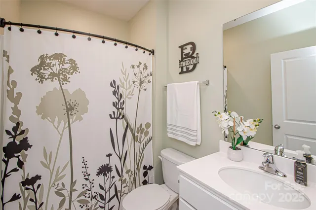 a bathroom with a sink and mirror with toilet