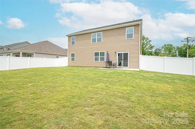 a view of a house with a backyard