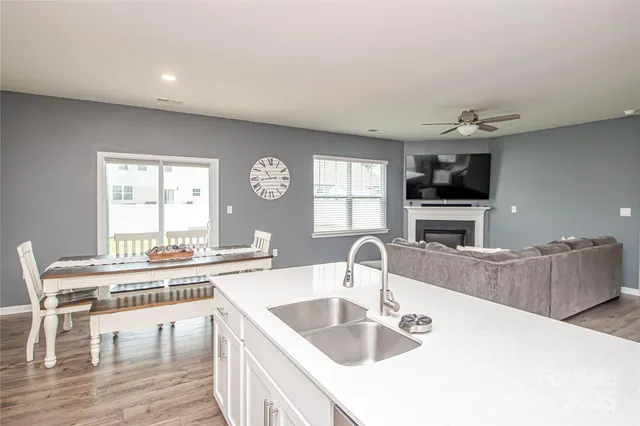 a kitchen with granite countertop a sink and a stove top oven