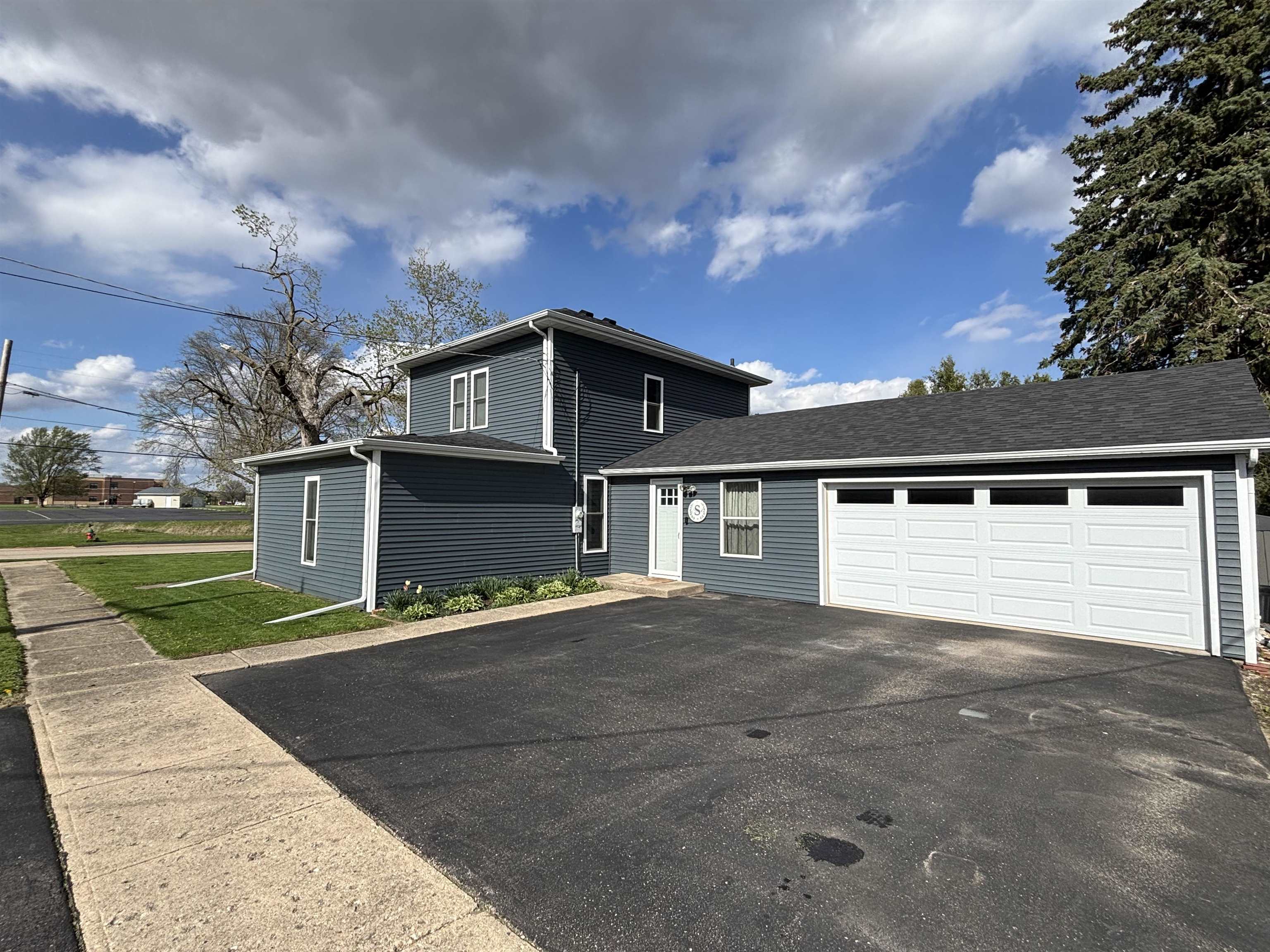 732 West 2nd Street Byron, IL 61010 - Photo 1 of 22 a front view of a house with a yard and garage