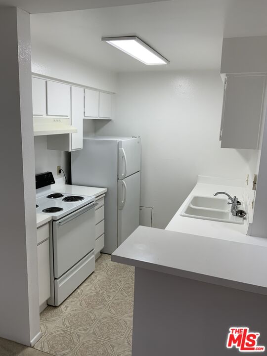 4107 Raintree Circle Culver City, CA 90230 - Photo 13 of 23 a kitchen with a sink cabinets and appliances