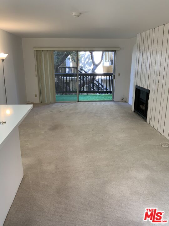 4107 Raintree Circle Culver City, CA 90230 - Photo 14 of 23 a view of an empty room with kitchen and window