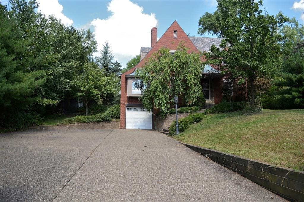 138 Siebert Road Pittsburgh, PA 15237 - Photo 2 of 25 Front Exterior: This home sits far back from the road. In fact, the exposed aggregate driveway is so large that it can easily hold eight cars. There is a one car integral garage with an automatic garage door opener. The retaining walls and the exposed aggregate steps and walkway to the front entry are in fine repair. The architecture is gorgeous--the sloping slate roof, a nearly all-brick exterior, the bay window with a copper roof and the side dormers contribute to the appealing look.