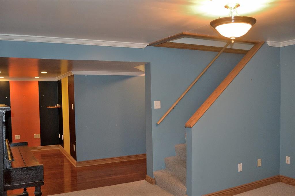 138 Siebert Road Pittsburgh, PA 15237 - Photo 21 of 25 The hardwood floored area across from the game room was utilized as an office area. The hardwood hallway leads to the laundry/storage room and the garage. There is also a cold cellar under the front porch to store all the canned delights that you "put up" from your garden.