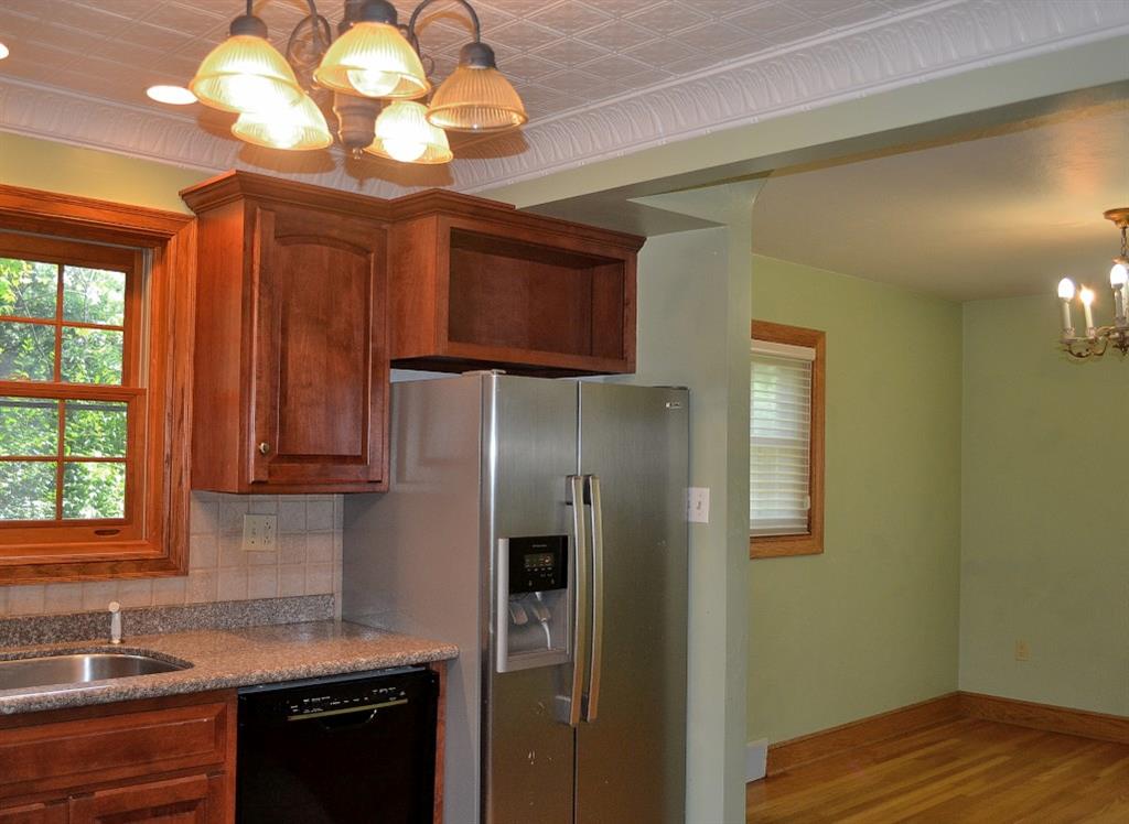 138 Siebert Road Pittsburgh, PA 15237 - Photo 8 of 25 Kitchen: The remodeled kitchen has a tin ceiling and a new light fixture. There are granite countertops, mostly all stainless steel appliances, cherry cabinetry, a stainless steel sink and ceramic flooring.